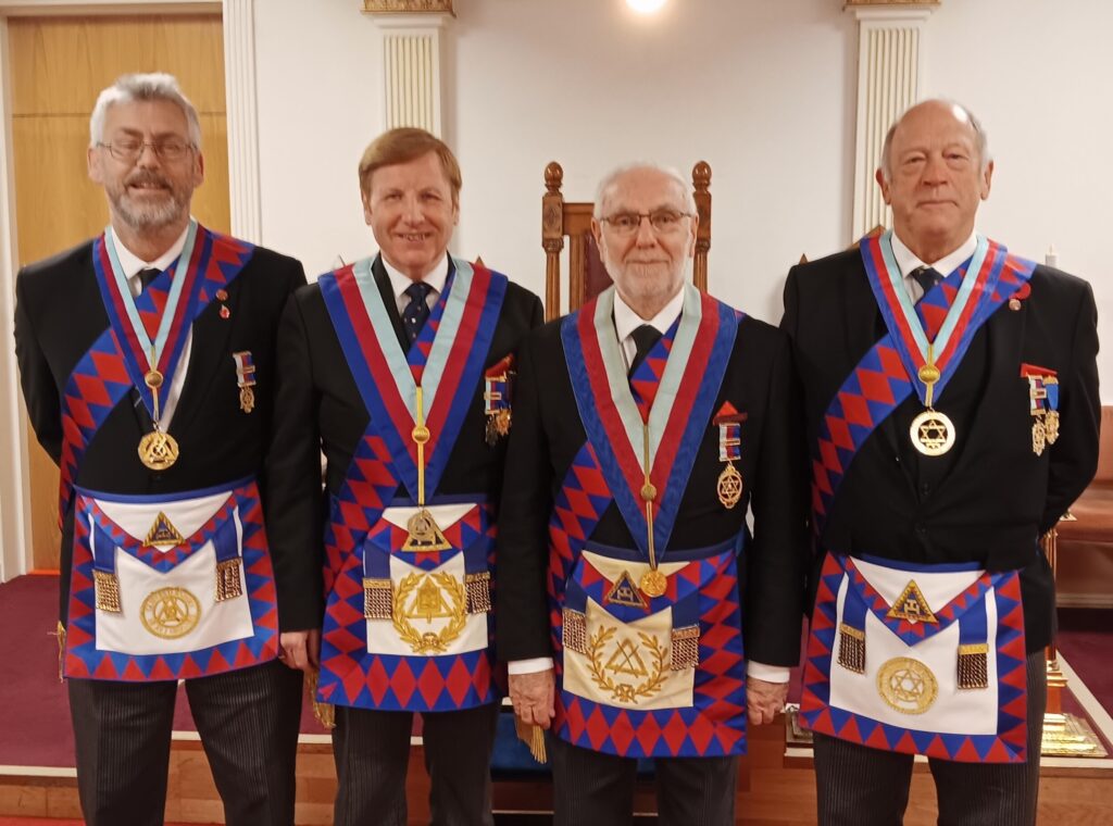 four royal arch masons stood together in regalia