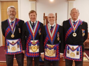 four royal arch masons stood together in regalia