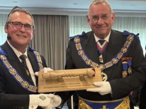 RW Bro Ian Davies presenting the Travelling Sceptre to the MEGS E. Comp. Michael Holland