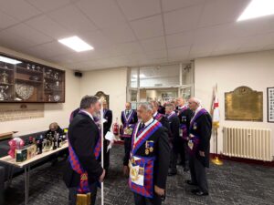 a procession of royal arch masons getting ready to enter a meeting